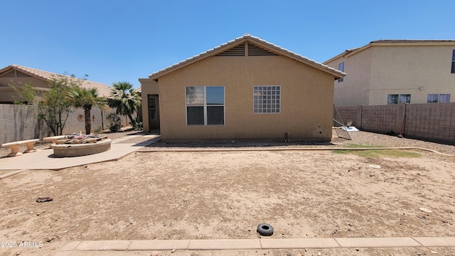 4432 W Pleasant Ln, Laveen, AZ 85339 - back of house with a fire pit, a patio, a fenced backyard, a tile roof, and stucco siding