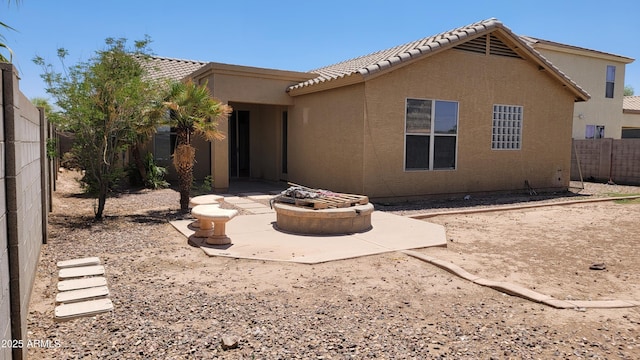 4432 W Pleasant Ln, Laveen, AZ 85339 - back of property with an outdoor fire pit, stucco siding, a patio, a fenced backyard, and a tiled roof