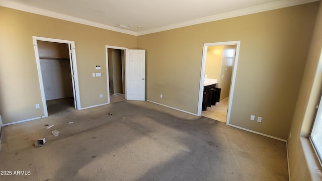 4432 W Pleasant Ln, Laveen, AZ 85339 - unfurnished bedroom featuring crown molding, baseboards, carpet, a walk in closet, and ensuite bathroom