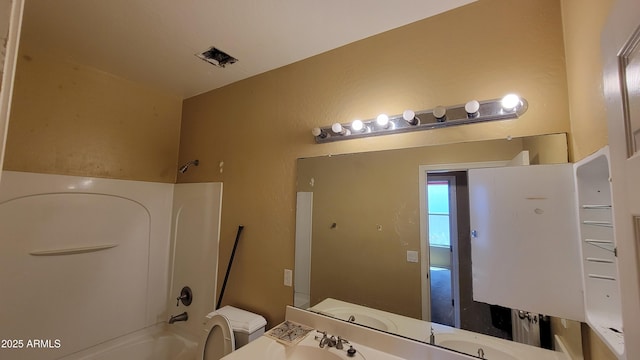 4432 W Pleasant Ln, Laveen, AZ 85339 - full bathroom with washtub / shower combination, vanity, and toilet