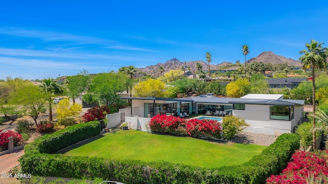 4218 E Palo Verde Dr, Phoenix, AZ 85018 - back of property with a lawn, stucco siding, a mountain view, and fence