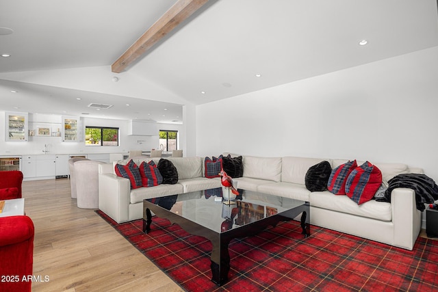 4218 E Palo Verde Dr, Phoenix, AZ 85018 - living room featuring light wood-style flooring, bar area, recessed lighting, visible vents, and vaulted ceiling with beams