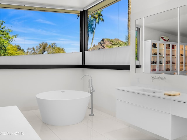 4218 E Palo Verde Dr, Phoenix, AZ 85018 - bathroom with tile patterned floors, a freestanding bath, and vanity