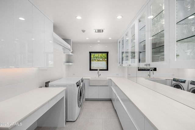 4218 E Palo Verde Dr, Phoenix, AZ 85018 - laundry area featuring recessed lighting, light tile patterned floors, a sink, washing machine and clothes dryer, and cabinet space