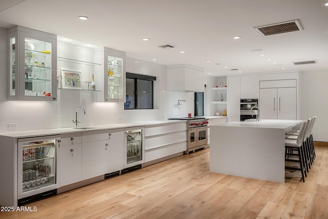 4218 E Palo Verde Dr, Phoenix, AZ 85018 - kitchen with wine cooler, double oven range, modern cabinets, and visible vents