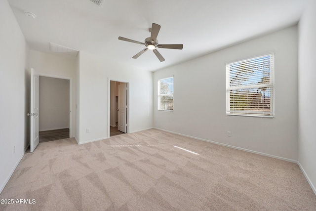 unfurnished bedroom with ceiling fan, baseboards, and light colored carpet