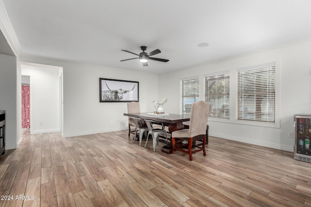 dining room with light hardwood / wood-style flooring, wine cooler, ceiling fan, and ornamental molding