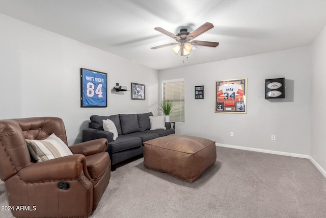 carpeted living room with ceiling fan