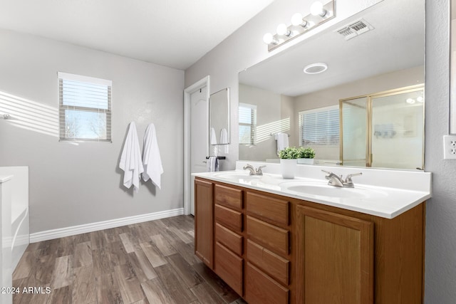 bathroom with vanity, shower with separate bathtub, and hardwood / wood-style flooring