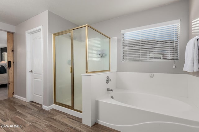 bathroom featuring hardwood / wood-style flooring and independent shower and bath