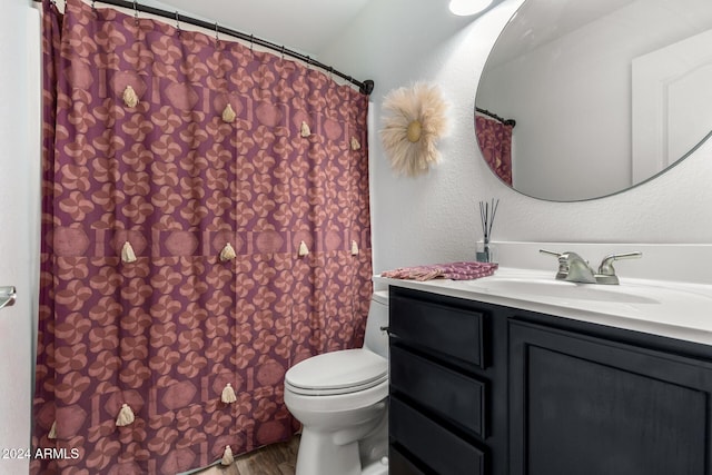 bathroom featuring hardwood / wood-style flooring, vanity, and toilet