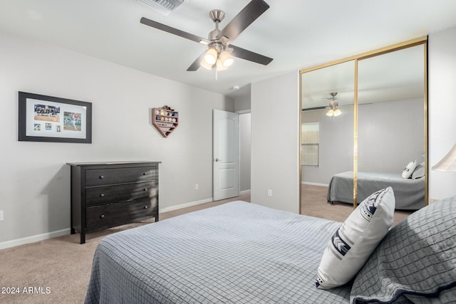 bedroom featuring light carpet, a closet, and ceiling fan