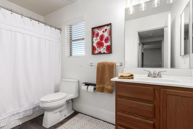 bathroom with hardwood / wood-style floors, vanity, and toilet