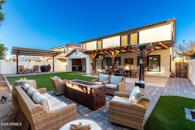 back of property with a pergola, a patio area, and an outdoor living space with a fire pit