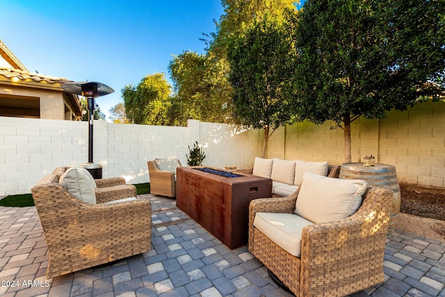 view of patio with an outdoor living space with a fire pit