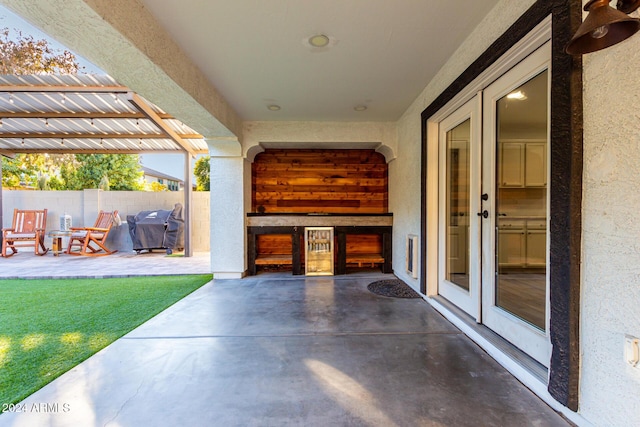 view of patio with a grill, a pergola, and french doors