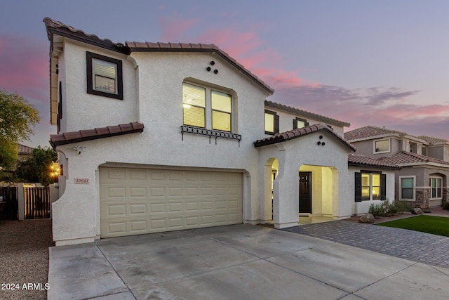 mediterranean / spanish house featuring a garage