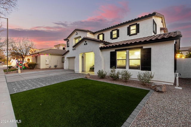 view of front of house featuring a yard and a garage