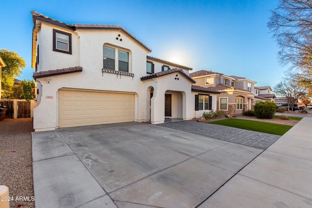 mediterranean / spanish home with a garage