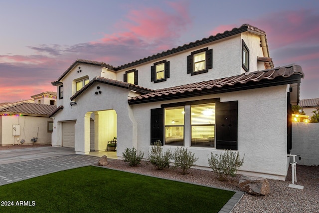 mediterranean / spanish-style home with a garage