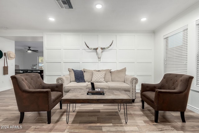 living room featuring crown molding and ceiling fan