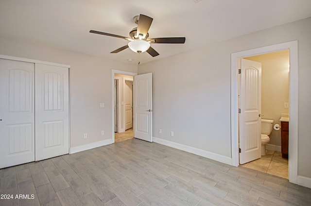 6120 W Keim Dr, Glendale, AZ 85301 - unfurnished bedroom featuring a closet, light wood-type flooring, and baseboards