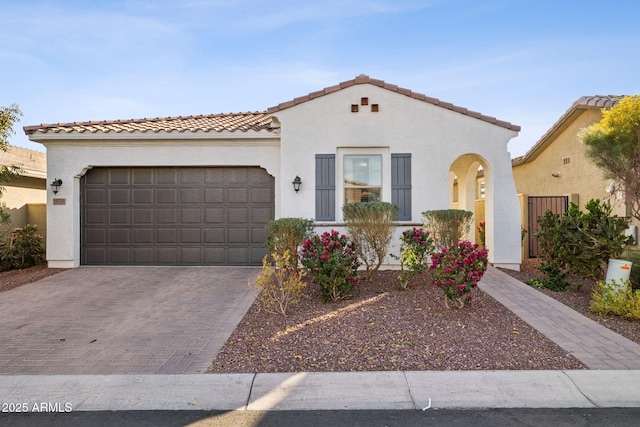 mediterranean / spanish home with a garage