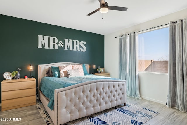 bedroom with ceiling fan and wood-type flooring