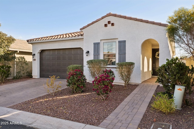 mediterranean / spanish house featuring a garage