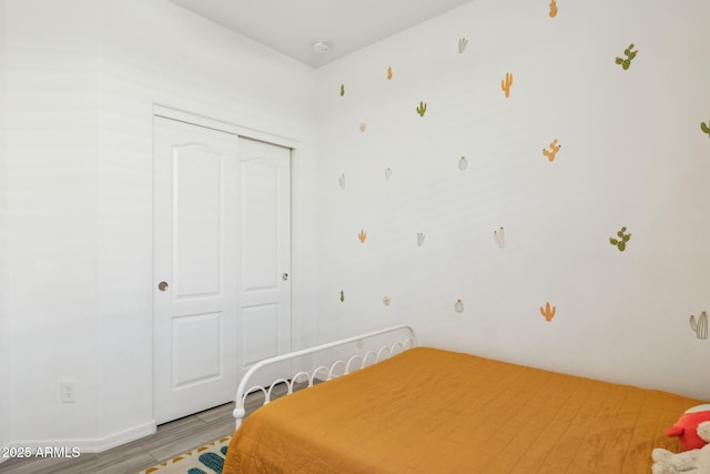 bedroom with hardwood / wood-style flooring and a closet