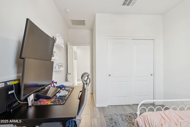 bedroom featuring light hardwood / wood-style floors and a closet