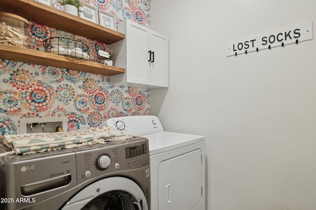 washroom featuring cabinets and independent washer and dryer