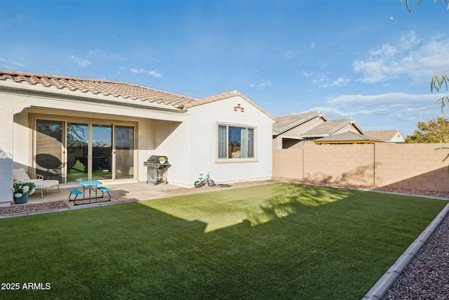 rear view of house with a yard and a patio