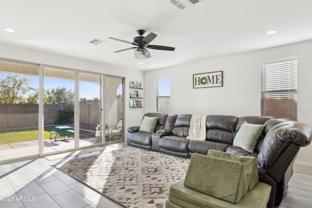 living room with plenty of natural light and ceiling fan