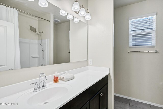 full bath with visible vents, curtained shower, vanity, and tile patterned flooring