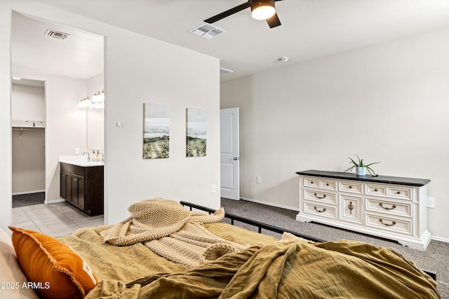 bedroom with ceiling fan, baseboards, visible vents, and light carpet