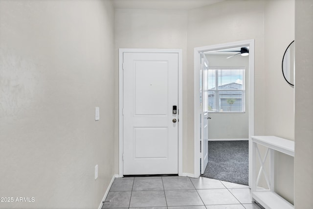 entrance foyer with light tile patterned floors and baseboards