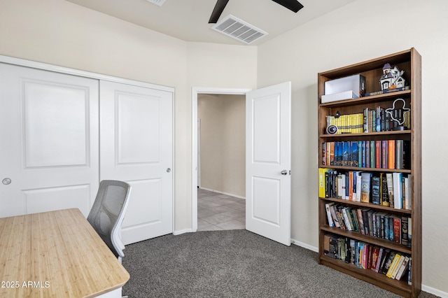 tiled office space featuring baseboards, visible vents, a ceiling fan, and carpet