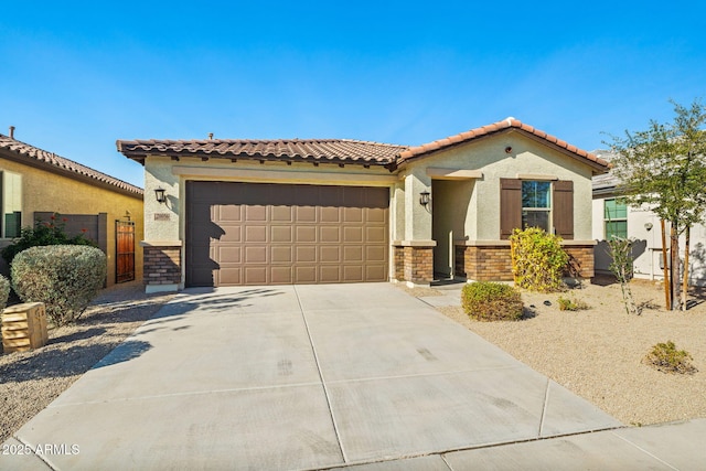 mediterranean / spanish-style home with a garage, a tile roof, driveway, stone siding, and stucco siding