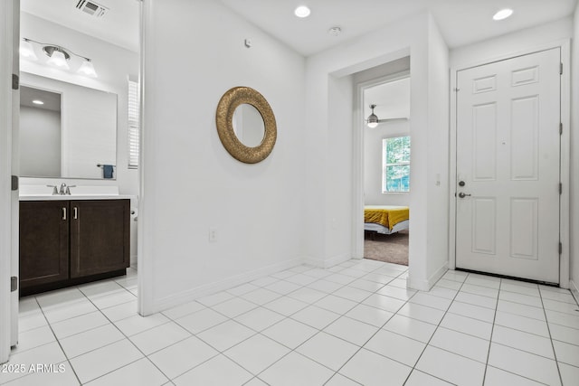 entryway featuring light tile patterned floors, recessed lighting, visible vents, ceiling fan, and baseboards