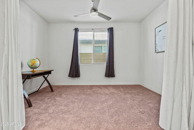 empty room featuring light carpet, ceiling fan, and baseboards