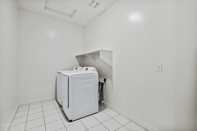 laundry room with light tile patterned floors, attic access, separate washer and dryer, laundry area, and baseboards