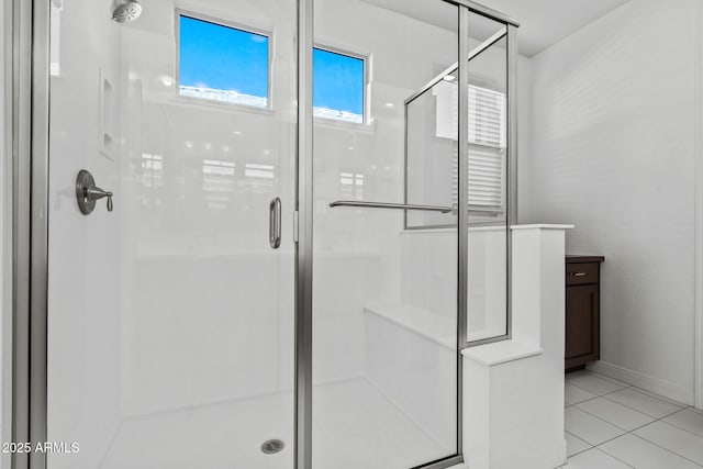 bathroom with a shower stall and tile patterned floors