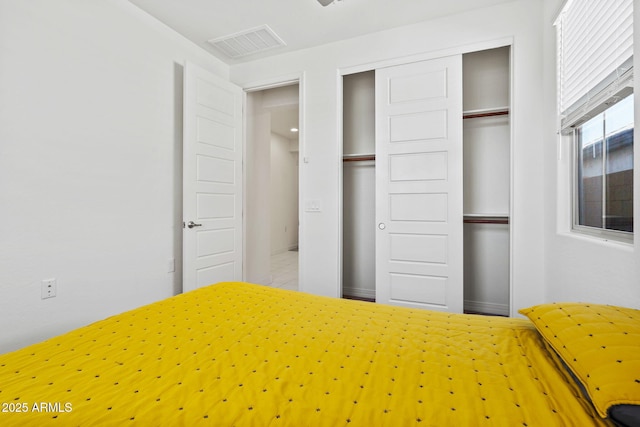 unfurnished bedroom with a closet and visible vents