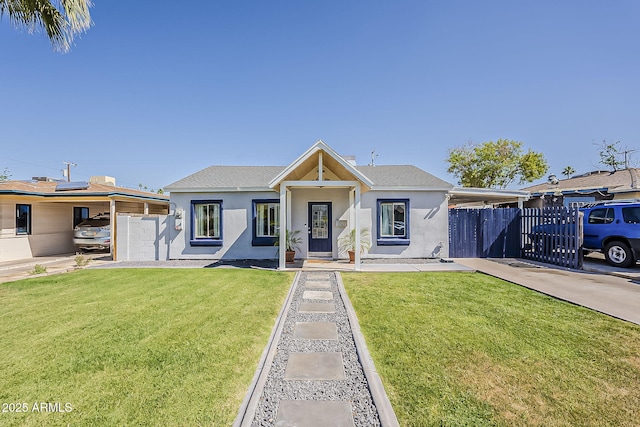 view of front facade with fence, a front lawn, and stucco siding