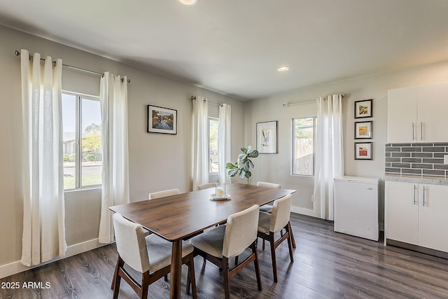 dining room featuring a healthy amount of sunlight, baseboards, recessed lighting, and dark wood-style floors