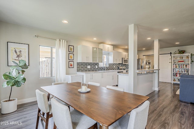 dining area with baseboards, recessed lighting, dark wood-style floors, and a barn door
