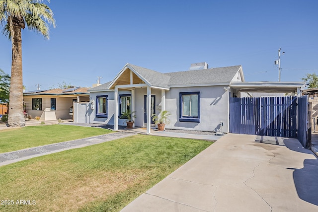ranch-style home featuring a shingled roof, stucco siding, an attached carport, a front yard, and driveway