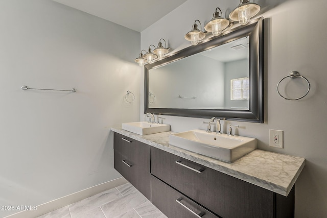 bathroom featuring baseboards, visible vents, a sink, and marble finish floor