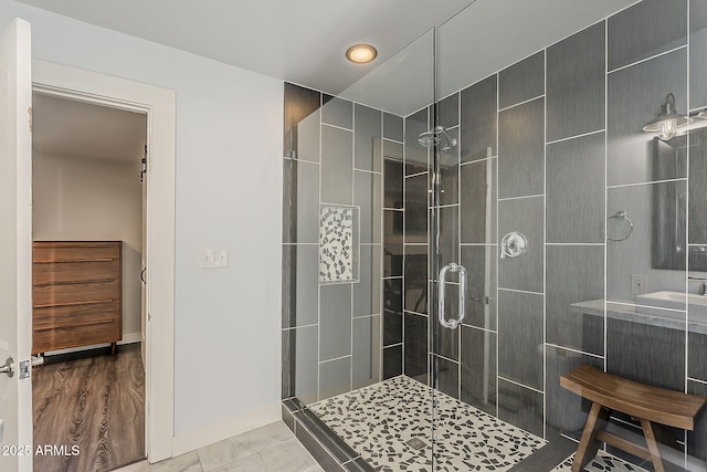 bathroom featuring baseboards, recessed lighting, and a stall shower